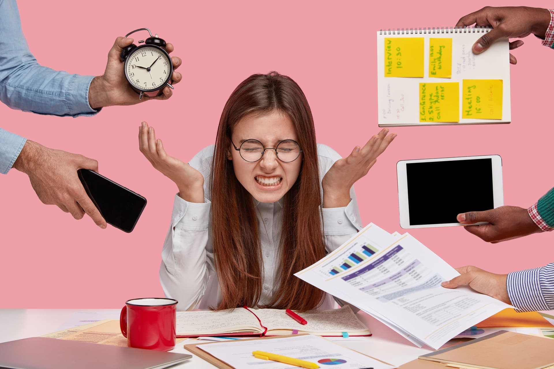 brunette-woman-sitting-desk-surrounded-with-gadgets-papers 1.jpg